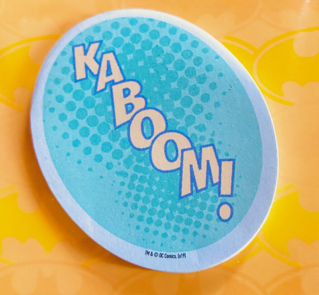 Runder Aufkleber mit dem Schriftzug 'KABOOM!' in Comic-Schrift auf blauem Hintergrund